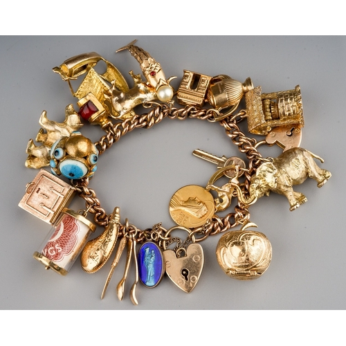 104 - A 9ct yellow gold charm bracelet, the curb-link bracelet suspending various yellow gold charms inclu... 