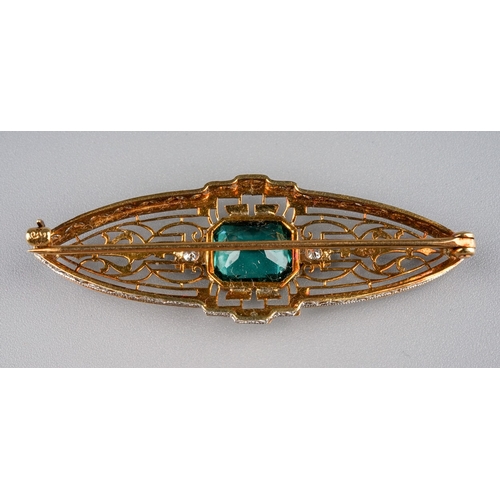 139 - A 14k gold tourmaline and diamond brooch, in the Belle Epoque style, set with an octagonal-cut green... 