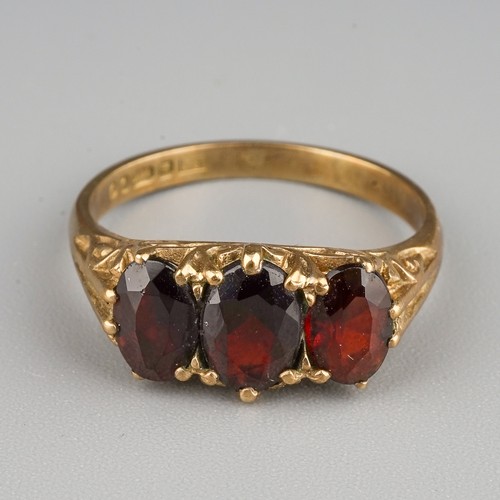 207 - A 9ct yellow gold and garnet three-stone ring, size L1/2, gross weight approx 2.7g