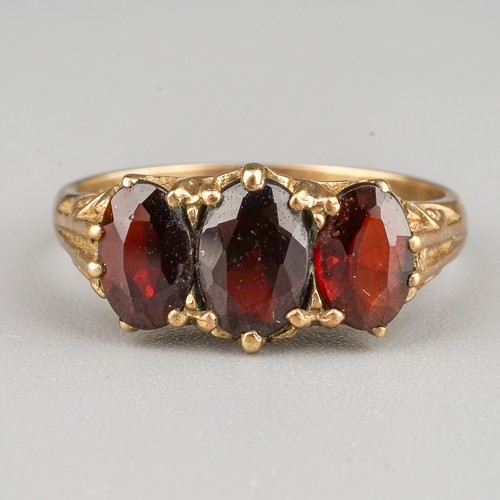 207 - A 9ct yellow gold and garnet three-stone ring, size L1/2, gross weight approx 2.7g