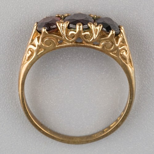 207 - A 9ct yellow gold and garnet three-stone ring, size L1/2, gross weight approx 2.7g