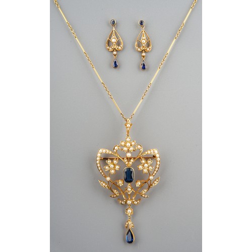 230 - An Edwardian 15ct yellow gold sapphire and seed pearl openwork pendant brooch, set with synthetic sa...