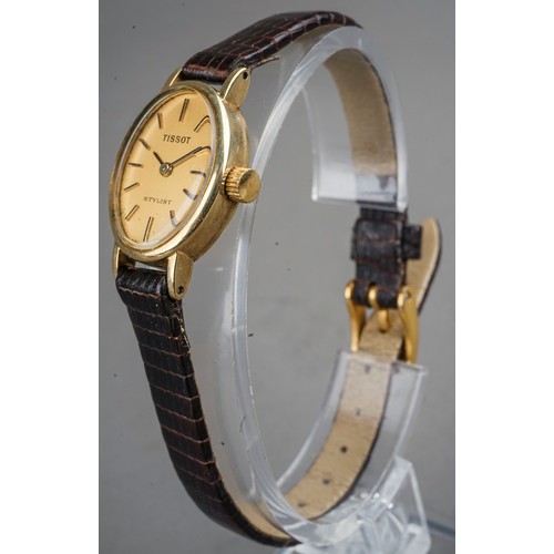 252 - A ladies 9ct yellow gold case Tissot wristwatch, brown leather strap