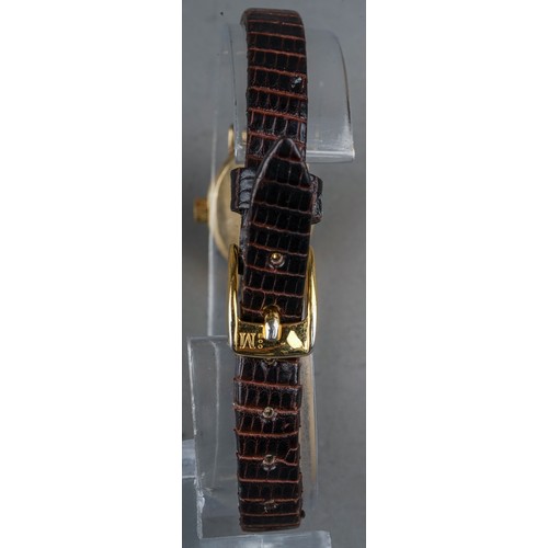 252 - A ladies 9ct yellow gold case Tissot wristwatch, brown leather strap