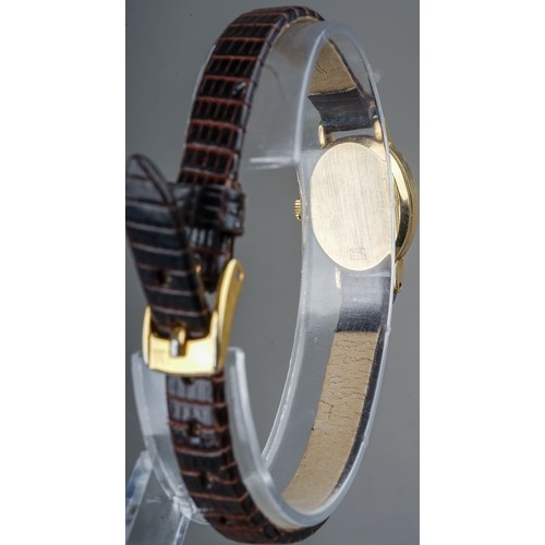 252 - A ladies 9ct yellow gold case Tissot wristwatch, brown leather strap