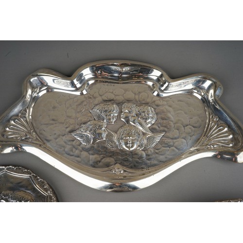 265 - An Edwardian silver dressing table tray, the centre embossed with Reynold's Angels, raised border, h... 