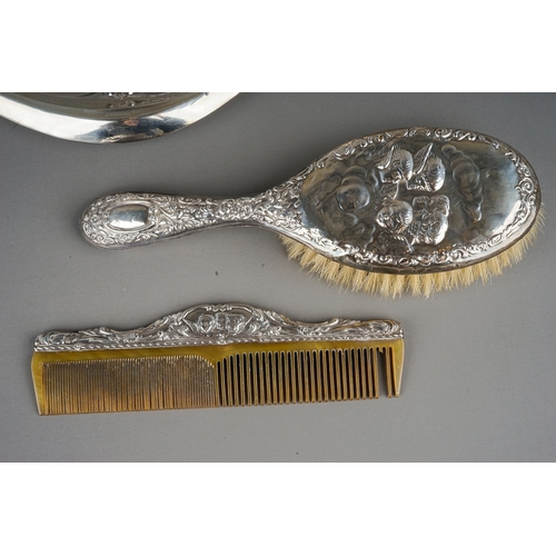 266 - An early 20th Century silver mounted part dressing table set to include mirror, hair brush and comb,... 