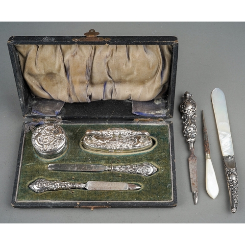 283 - An Edwardian silver boxed manicure set, hallmarked Chester, 1909 together with three further impleme... 