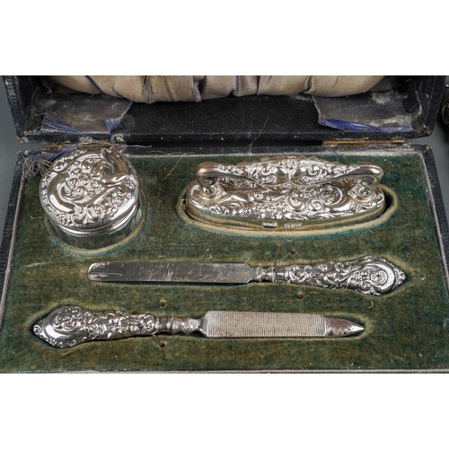 283 - An Edwardian silver boxed manicure set, hallmarked Chester, 1909 together with three further impleme... 