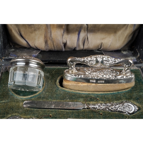 283 - An Edwardian silver boxed manicure set, hallmarked Chester, 1909 together with three further impleme... 