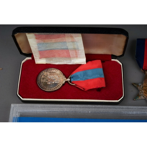 336 - A cased Elizabeth II Faithful Service medal awarded to Edwin Woodhall Strachan, with spare ribbon, a... 