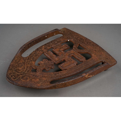 340 - An early 20th century cast iron flat iron stand featuring a good luck symbol