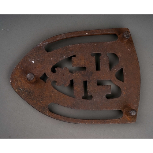 340 - An early 20th century cast iron flat iron stand featuring a good luck symbol