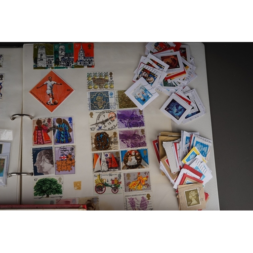 352 - A collection of stamps housed in a ring bound folder, a Godden Royal Mail album, a Quickchange album... 