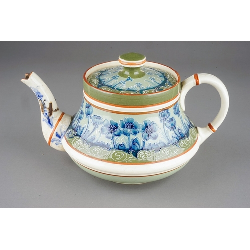 362 - A Moorcroft Macintyre tea pot of squat baluster form, tube line decorated with blue poppies on a gre... 