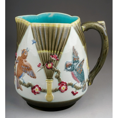 371 - A late 19th century Wedgwood majolica jug, relief decorated in the Aesthetic taste with fans and bir... 