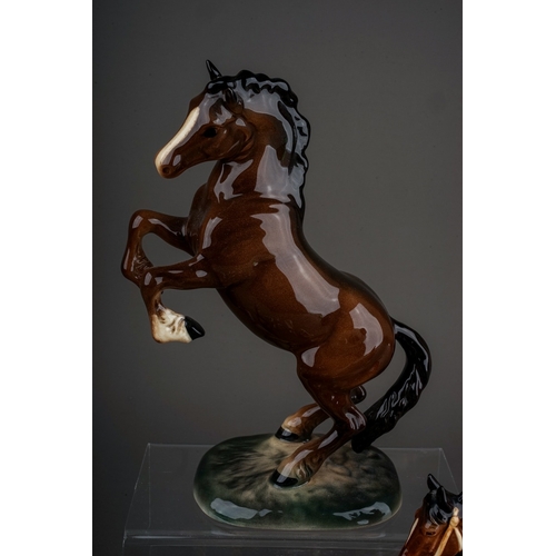 376 - A group of Beswick, Wade and other animal ceramics, including a Beswick Welsh Cob (rearing), model n... 