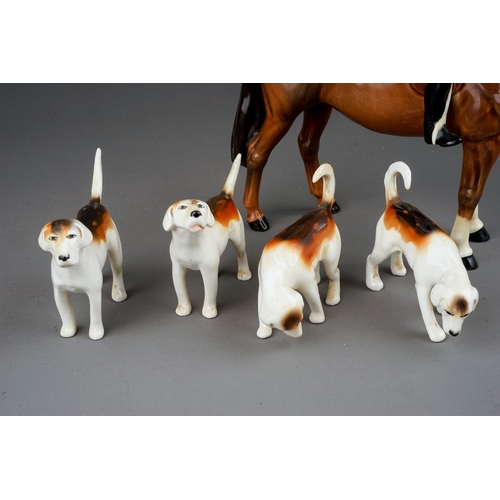 380 - A Beswick Huntsman standing on brown gloss horse, model no. 1501 and four Beswick foxhounds, all in ... 