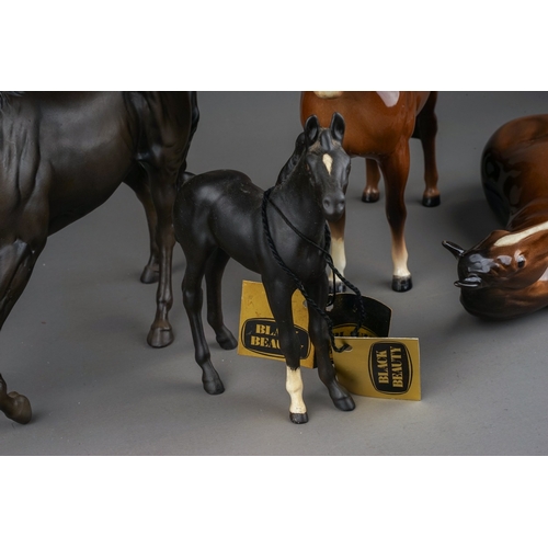 381 - Four Beswick horses foal, comprising Black Beauty, matt, model no.2466, Black Beauty foal, matt, mod... 