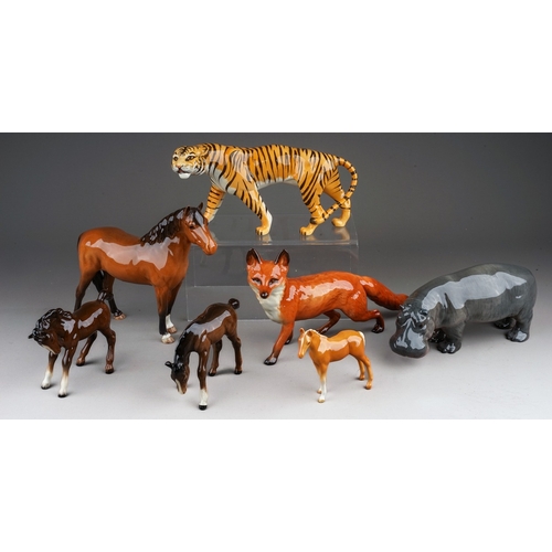 383 - Seven assorted Beswick animals, comprising a Hippo, gloss, model no.1532, Tigress, gloss model no. 1... 