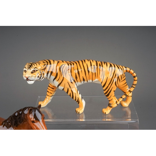 383 - Seven assorted Beswick animals, comprising a Hippo, gloss, model no.1532, Tigress, gloss model no. 1... 