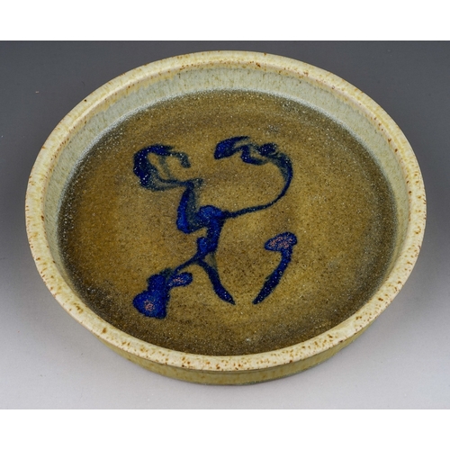 432 - A studio pottery circular shallow dish in manner of Mingei, the green glaze with abstract blue desig... 