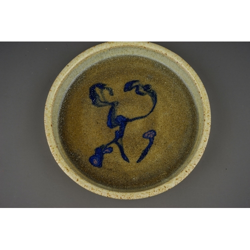 432 - A studio pottery circular shallow dish in manner of Mingei, the green glaze with abstract blue desig... 