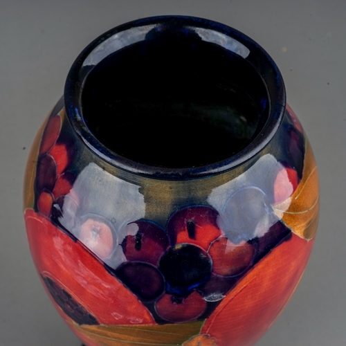 436 - A William Moorcroft Pomegranate pattern baluster vase with flared foot rim, blue ground, green signa... 