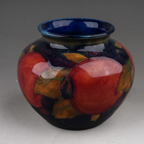 437 - A William Moorcroft Pomegranate pattern small vase, blue ground, impressed marks, height 6.5cm