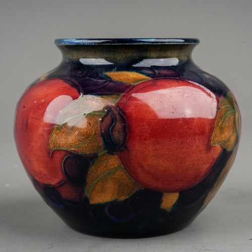 437 - A William Moorcroft Pomegranate pattern small vase, blue ground, impressed marks, height 6.5cm