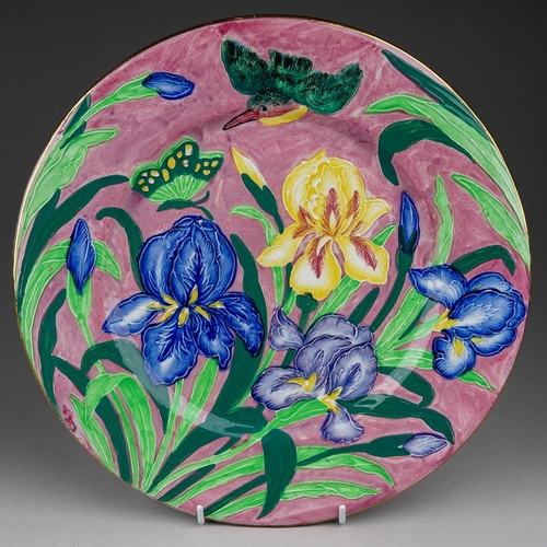 461 - A Maling circular wall plaque, circa 1930s,  embossed in relief with Irises, a butterfly and kingfis... 