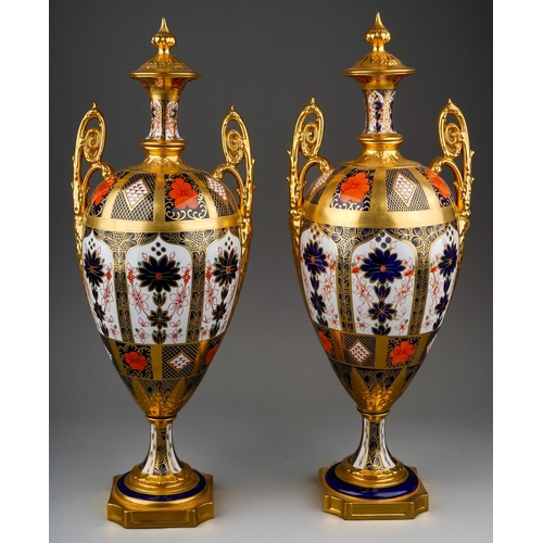 483 - A pair of Royal Crown Derby Imari 1128 solid gold band twin handled urns and covers, the three secti... 