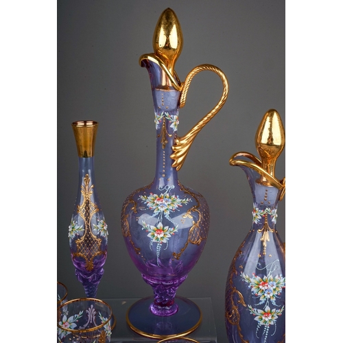 506 - A twenty-three piece Murano Cenesese Vetri liqueur set of purple glass, transfer printed, enamelled ... 