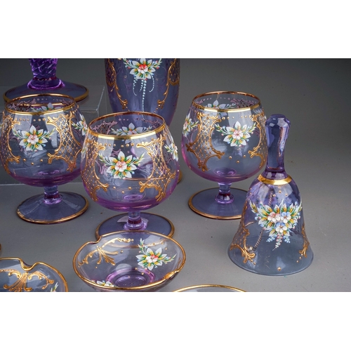 506 - A twenty-three piece Murano Cenesese Vetri liqueur set of purple glass, transfer printed, enamelled ... 