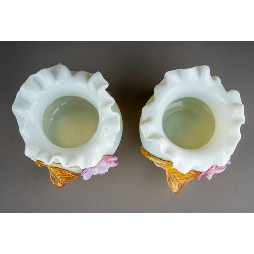 509 - A pair of 20th century milk glass vases of bulbous form, wavy rims, applied with an amber and pink g... 