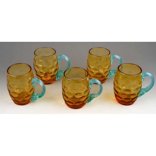 511 - A set of five 20th century dimpled amber glass tankards with twisted blue glass handles, height 10cm... 