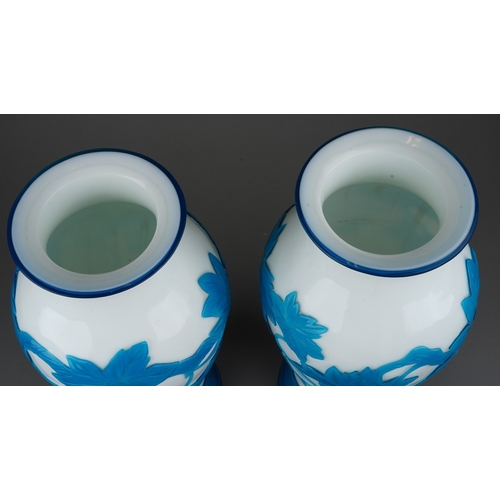 514 - A pair of Peking cameo glass blue and white vases, the white ground overlaid with a central band of ... 