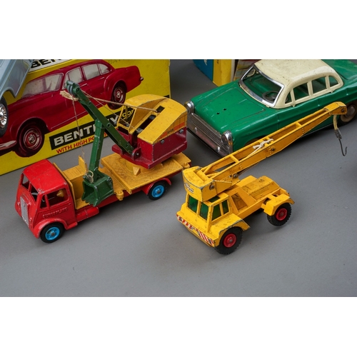 575 - A box of boxed and loose die cast, plastic and tin plate vehicles, the boxed cars comprise a Bandai ... 