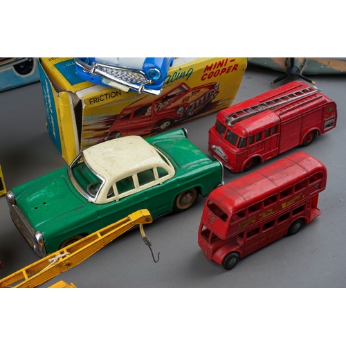 575 - A box of boxed and loose die cast, plastic and tin plate vehicles, the boxed cars comprise a Bandai ... 