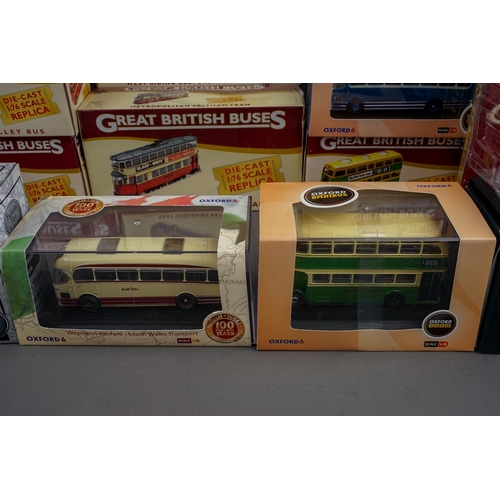 584 - A collection of twenty one modern boxed diecast buses, including a collection of fifteen Atlas Editi... 