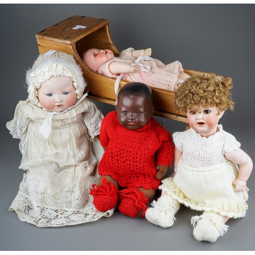 599 - Three early 20th Century German bisque head dolls to include: an Armand Marseille wearing Christenin... 