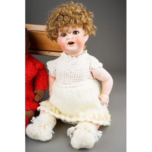 599 - Three early 20th Century German bisque head dolls to include: an Armand Marseille wearing Christenin... 