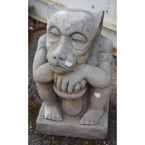 638 - A reconstituted stone garden ornament in the form of a Gargoyle