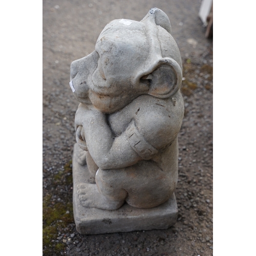 638 - A reconstituted stone garden ornament in the form of a Gargoyle