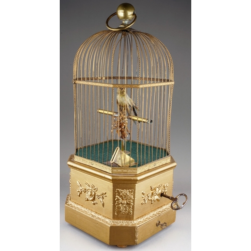 642 - A late 19th / early 20th century French gilt metal and giltwood automaton coin operated singing bird... 