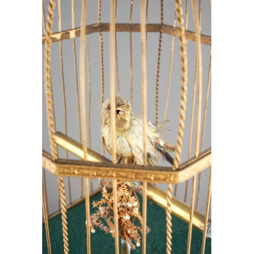 642 - A late 19th / early 20th century French gilt metal and giltwood automaton coin operated singing bird... 