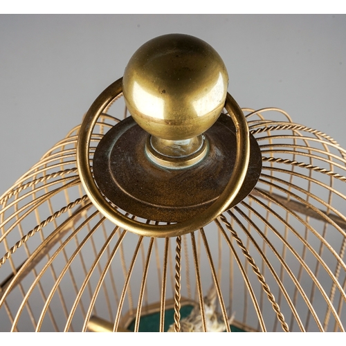 642 - A late 19th / early 20th century French gilt metal and giltwood automaton coin operated singing bird... 