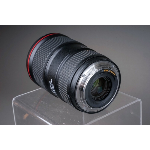 665 - A Canon EF 24-105MM MACRO L IS USM f/4 lens along with a Canon EF 16-35MM f/4 L IS USM lens and Sigm... 