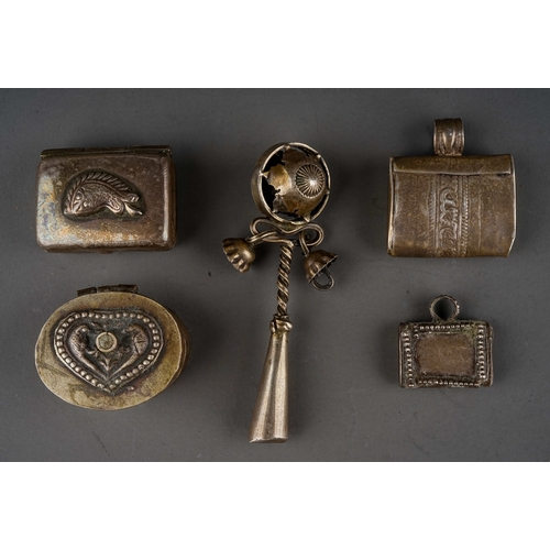 671 - A collection of five Indian white metal trinkets / charms, including a rattle with whistle, two pill... 