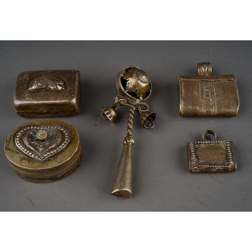 671 - A collection of five Indian white metal trinkets / charms, including a rattle with whistle, two pill... 